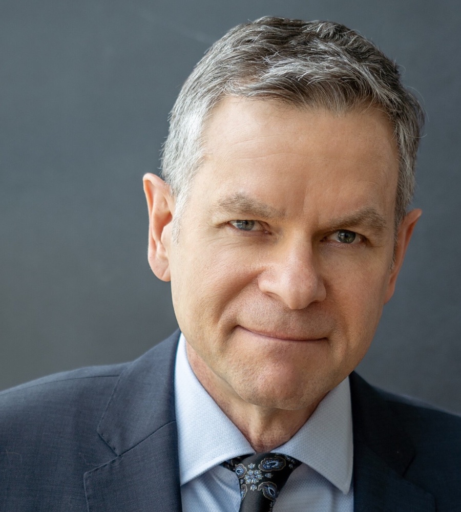 Graham Binks, head and shoulders, in a navy suit and blue shirt